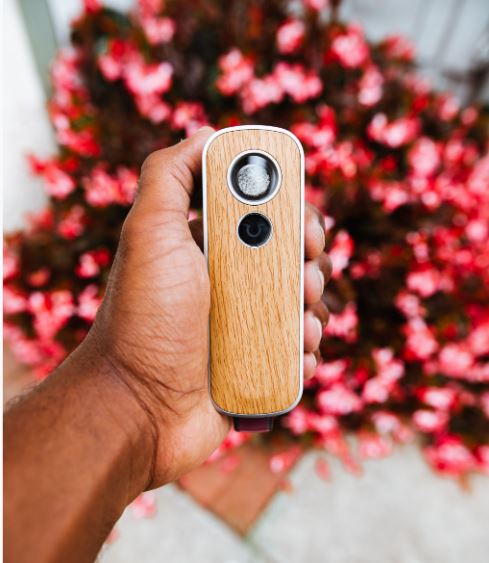 Firefly 2+ unit in hand above flowers