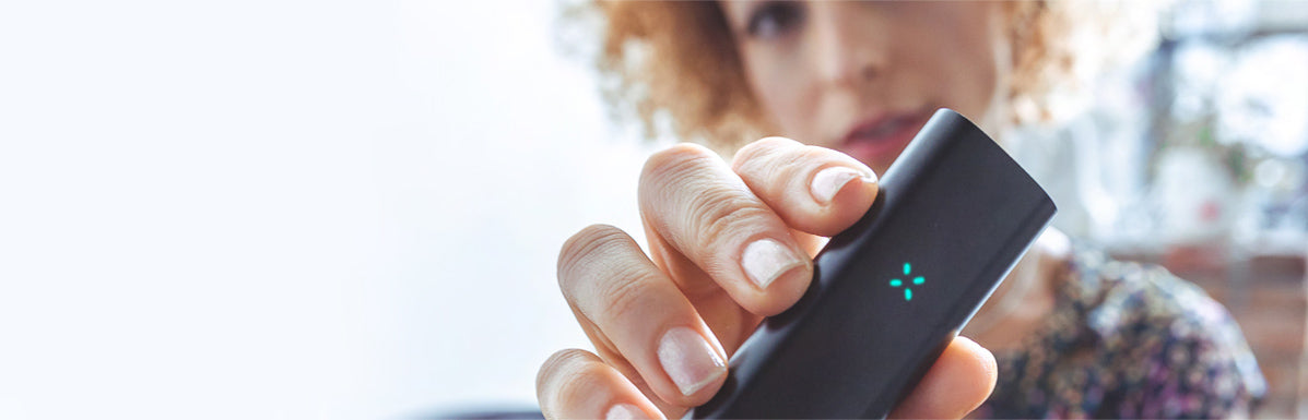 Lady holding the PAX vaporizer